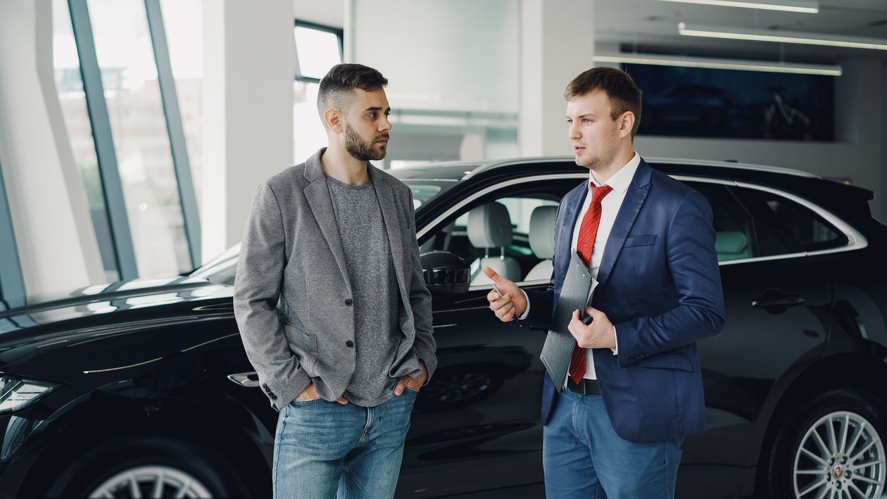 Salesperson talking with a buyer at the dealership